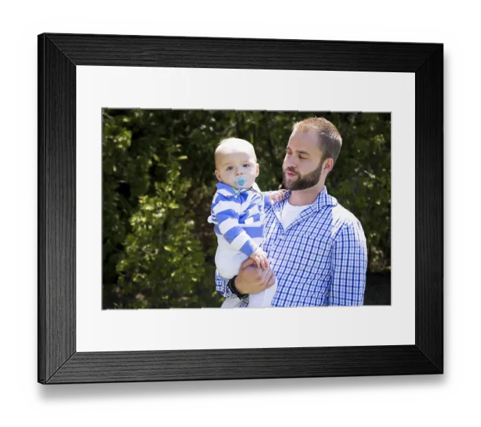 Framed Print : Young father holding one yeard old baby son outdoors Framed Print : Young father holding one yeard old baby son outdoors