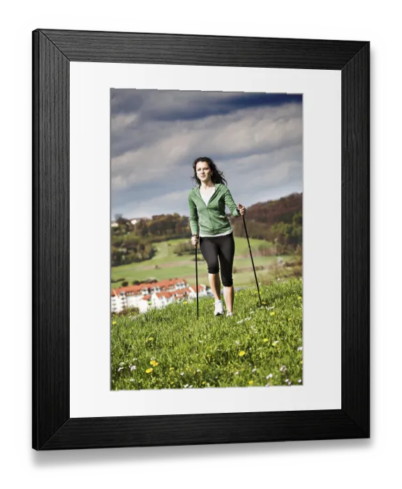 Framed Print : A young woman making nordic walking. outdoor shoot