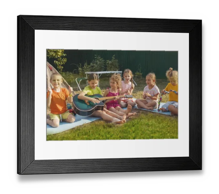 Framed Print : The elementary school boys and girls are sitting on the grass in the backyard Framed Print : The elementary school boys and girls are sitting on the grass in the backyard