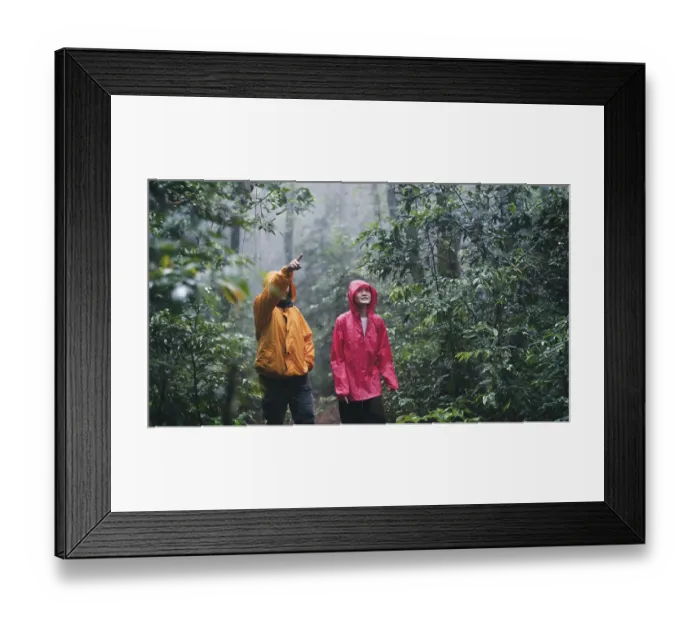Framed Print : A father and daughter wearing raincoats hiking exploring a misty