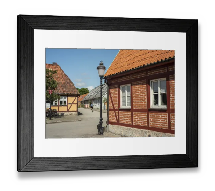 Framed Print : Small street with street lamp and half timbered house in Ystad