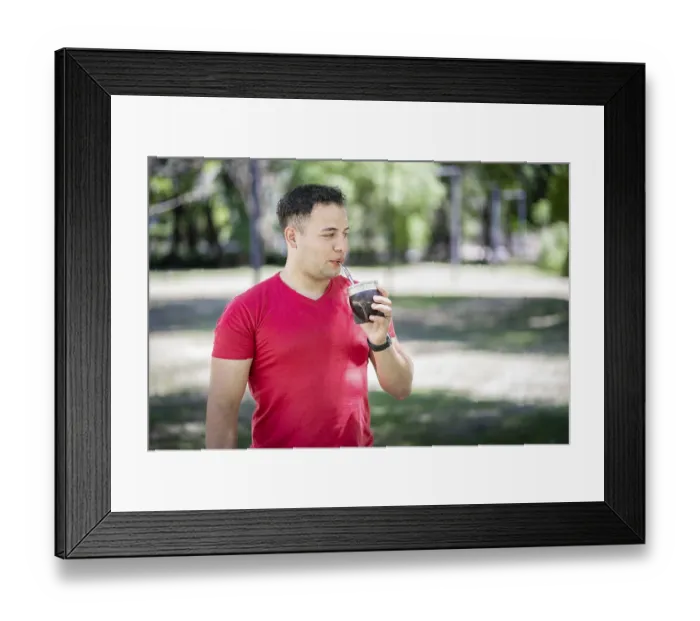 Framed Print : Latin man drinking mate in a park
