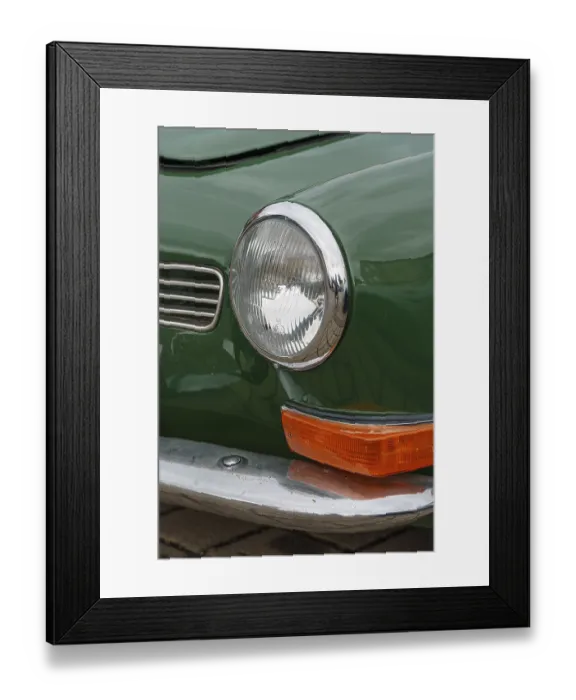 Framed Print : Front view of a green classic car with shiny headlights