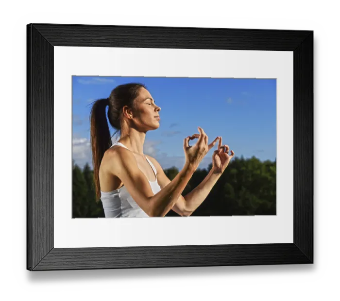 Framed Print : Young woman during yoga meditation in the park