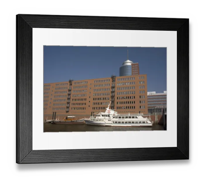 Framed Print : A trip boat is lying in front of the Hanseatic Trade Center HTC at Kehrwiederspitze at Hambug Hafencity Germany