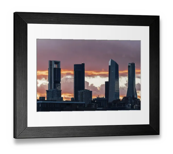 Framed Print : Madrid, Spain - December 8, 2024: Cuatro Torres Business Area set against a stunning Framed Print : Madrid, Spain - December 8, 2024: Cuatro Torres Business Area set against a stunning