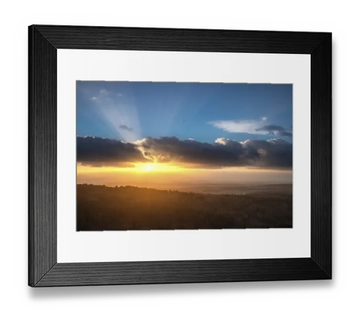 Framed Print : A Dramatic Sunset in the Evening with Clouds over a Valley in the Forest