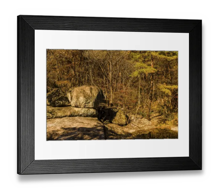 Framed Print : Large boulder in front of tree line beside pool of water in wilderness park Framed Print : Large boulder in front of tree line beside pool of water in wilderness park