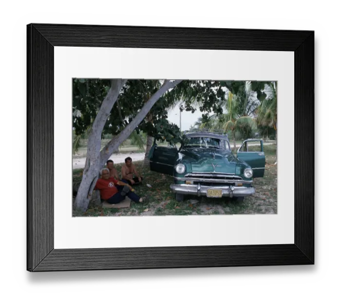 Framed Print : People sitting next to a vintage car