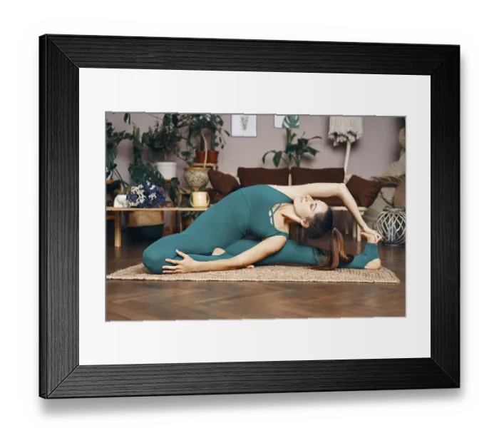 Framed Print : Young sporty woman practicing yoga at home doing revolved head to knee pose Framed Print : Young sporty woman practicing yoga at home doing revolved head to knee pose