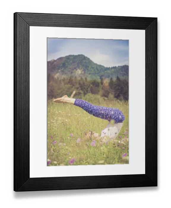 Framed Print : Young girl is doing yoga in the park