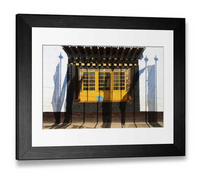Framed Print : Shadows of prayer flags against the colorful windows and wall of the Pemayagtse buddhist monastery in Pelling