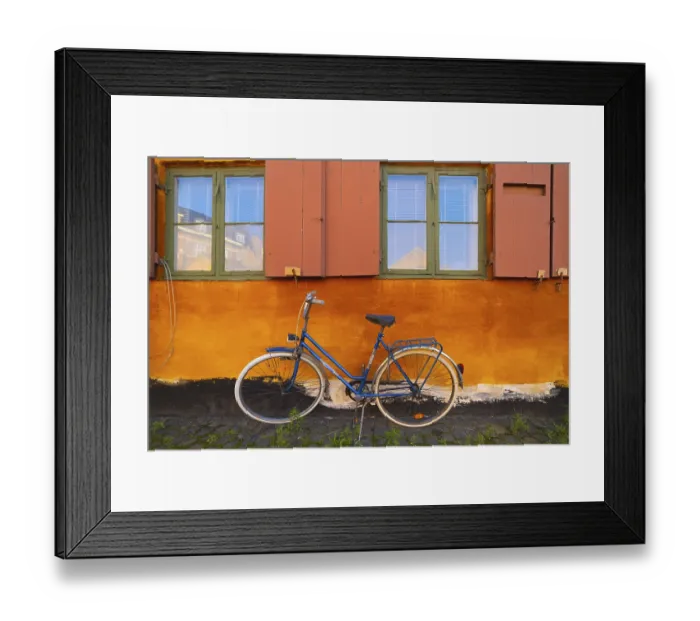 Framed Print : Bike leaning against the orange wall Framed Print : Bike leaning against the orange wall
