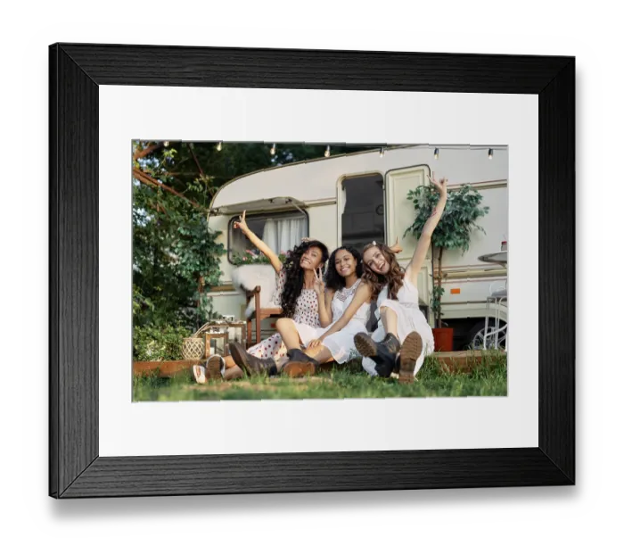 Framed Print : Happy multi ethnic girls raised arms posing near camper van outdoors