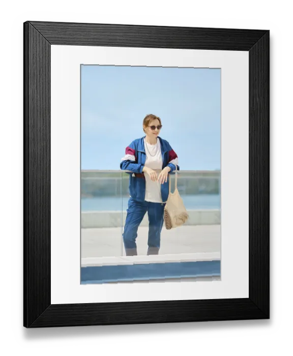 Framed Print : A woman stands by a glass railing at a waterfront location Framed Print : A woman stands by a glass railing at a waterfront location