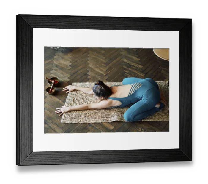 Framed Print : Young slim woman practicing yoga doing child's pose at home