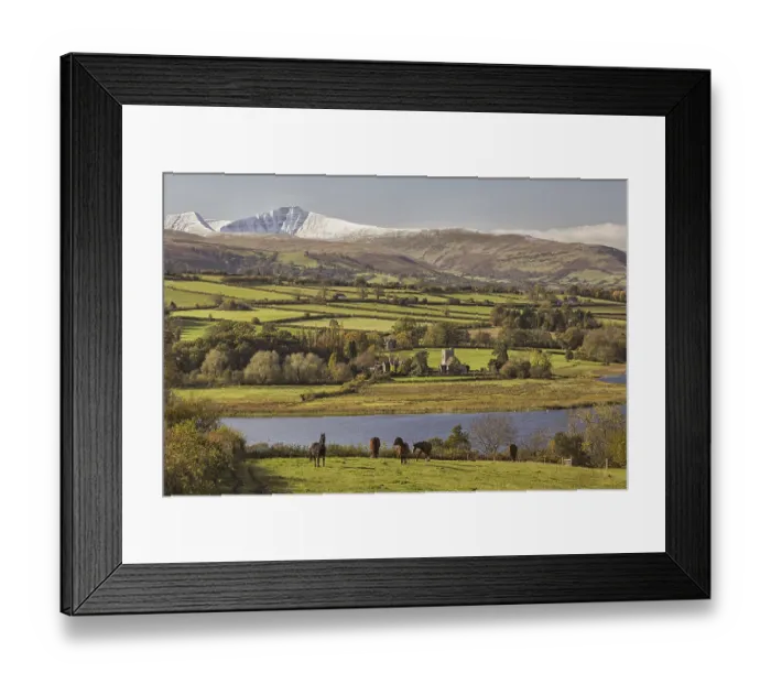 Framed Print : View of horses grazing, lake and snow-capped hills in the distance Framed Print : View of horses grazing, lake and snow-capped hills in the distance