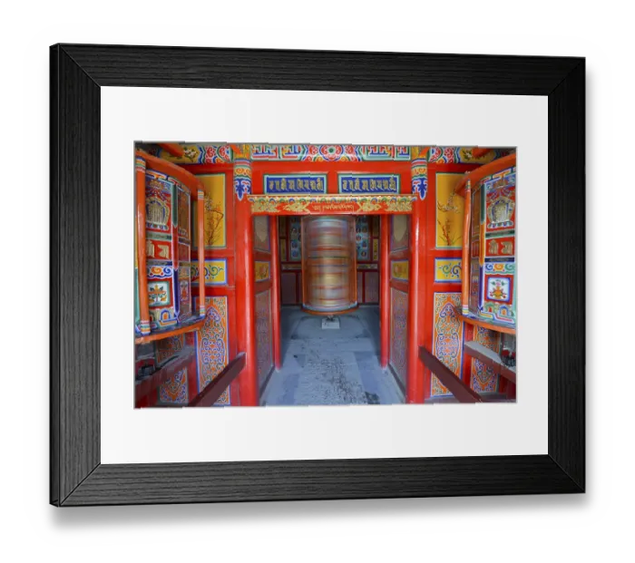 Framed Print : Tibetan Buddhism, a wooden prayer mill painted with symbols of Buddhism