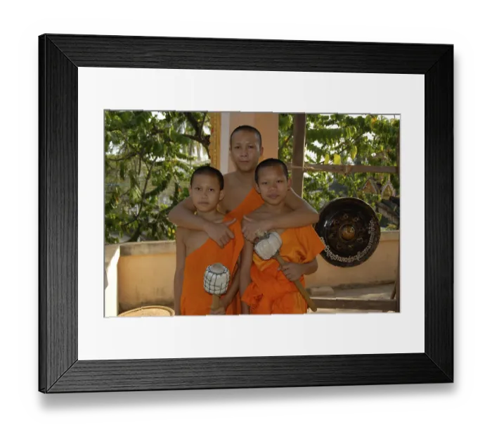 Framed Print : Buddhist monk embracing two novice monks