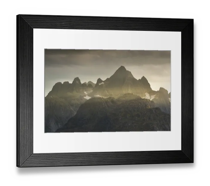 Framed Print : Rugged peaks of the mountain range Trolltindan in the rays of the evening sun