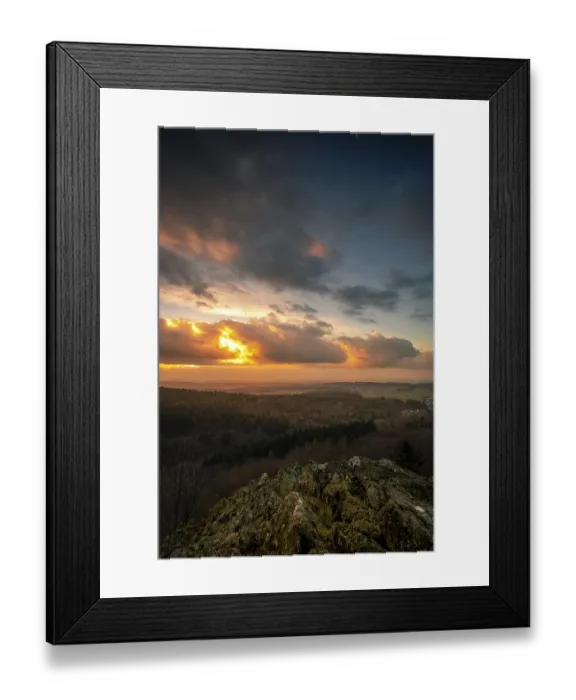 Framed Print : A Dramatic Sunset in the Evening with Clouds over a Valley in the Forest
