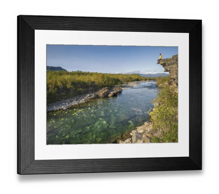 Framed Print : Man sitting on stone cliff over the river Abiskojakka Framed Print : Man sitting on stone cliff over the river Abiskojakka