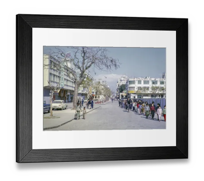 Framed Print : Primary school children walking hand in hand along city centre commercial street Framed Print : Primary school children walking hand in hand along city centre commercial street