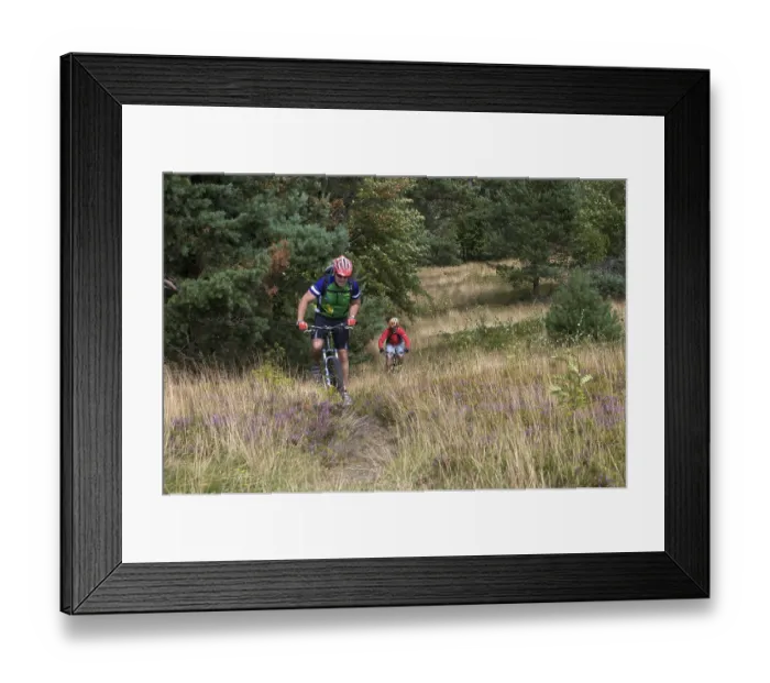 Framed Print : Mountain bike riders riding along a singletrail on Kahlen Poen mountain near Usseln