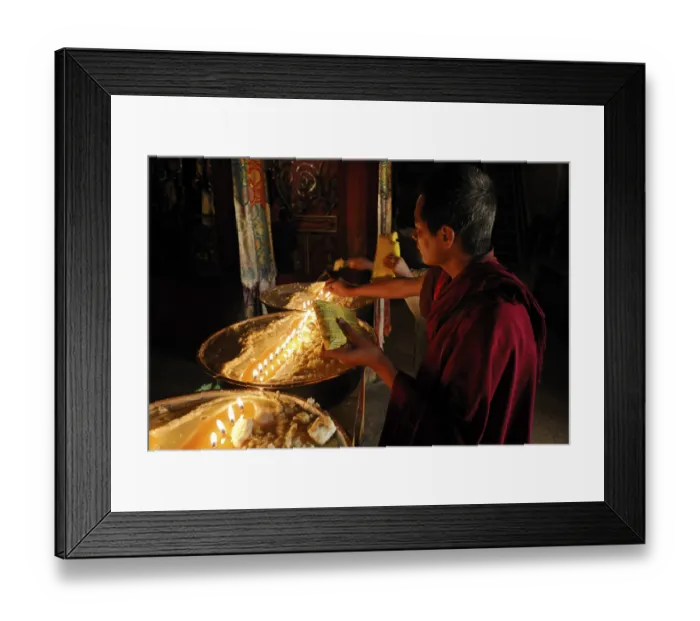 Framed Print : Pilgrim and Tibetan monks refilling the brass bow with yak butter