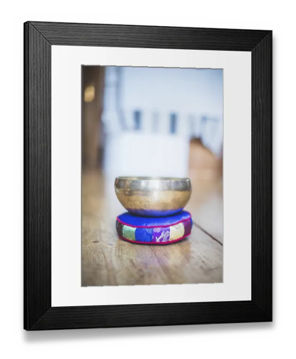 Framed Print : Metal singing bowl on a rustic wooden floor