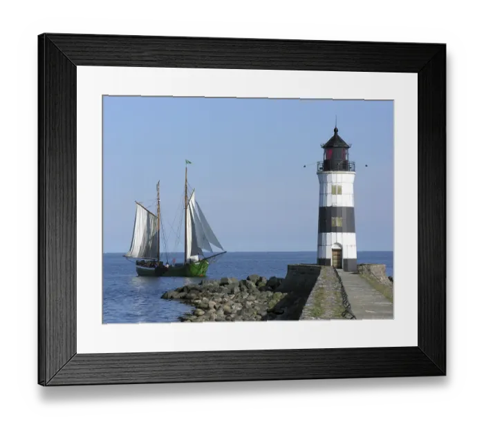 Framed Print : Vintage sailing yacht in front of the Schleimunde lighthouse Vintage sailing yacht in front of the Schleim