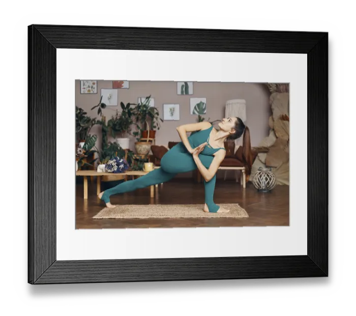 Framed Print : Young sporty woman practicing yoga at home doing half prayer twist pose