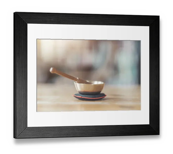 Framed Print : Small singing bowl on a rustic wooden table