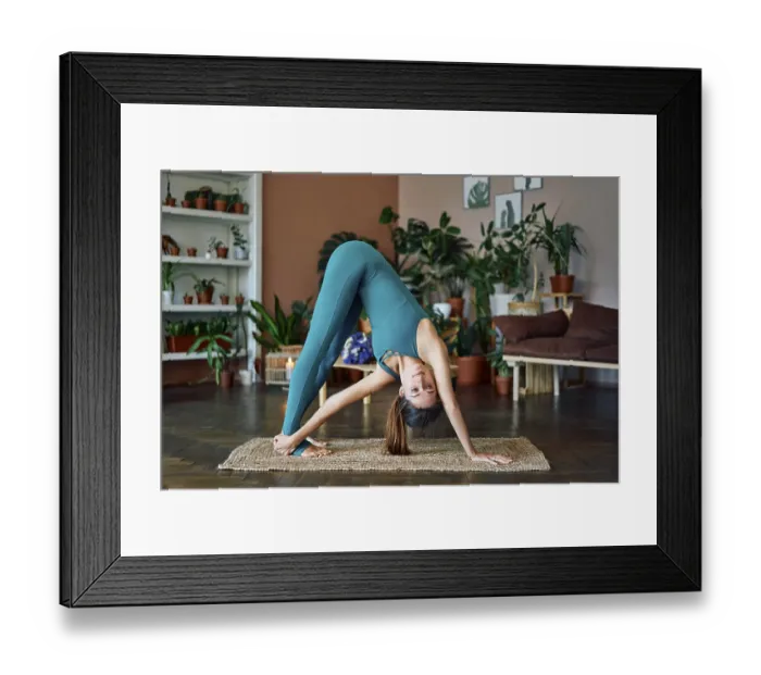 Framed Print : Young sporty woman practicing yoga at home doing asana revolved downward facing dog