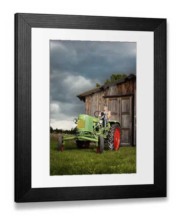 Framed Print : Man with a prosthetic leg driving a vintage tractor