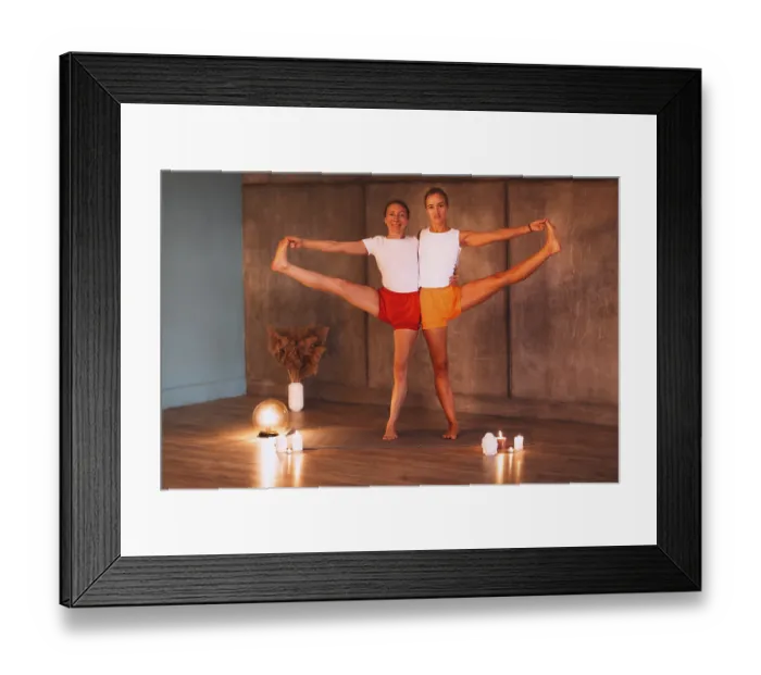 Framed Print : Two young slender women in colorful sportive wears doing yoga for relax