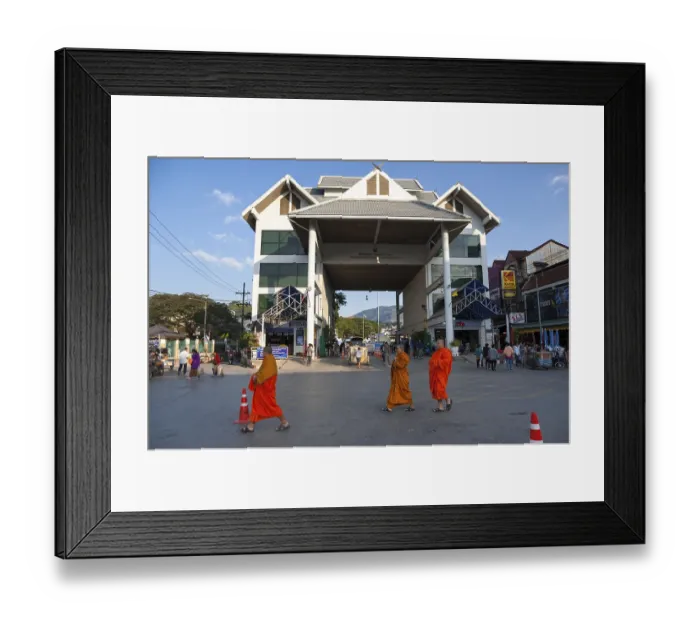 Framed Print : Monks walking in front of the border post between Myanmar Framed Print : Monks walking in front of the border post between Myanmar