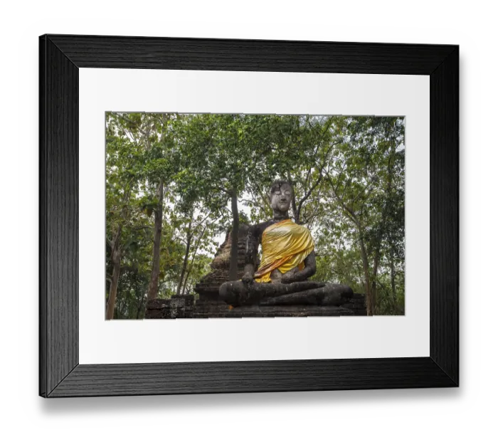 Framed Print : Seated Buddha statue in front of a chedi