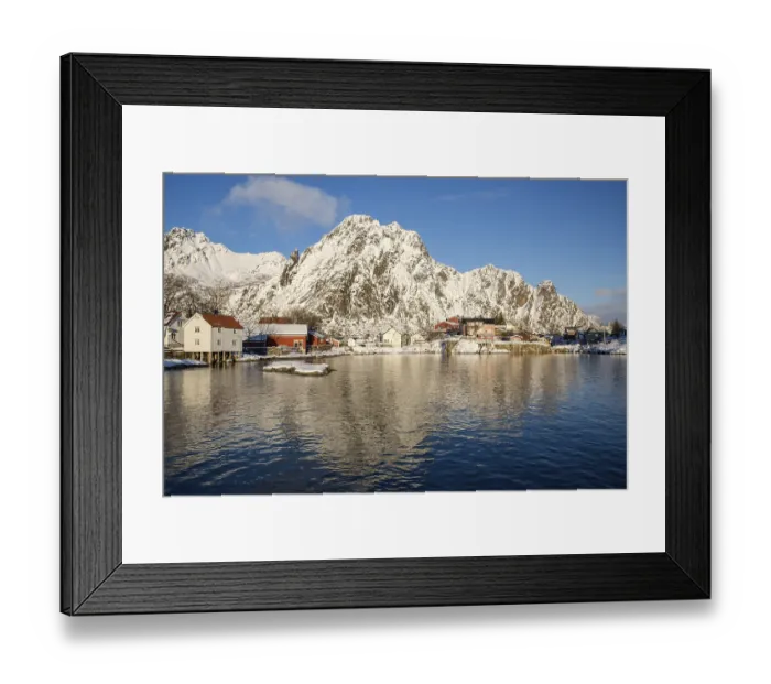 Framed Print : Houses at the harbor entrance of Svolvaer in front of snow-covered mountains