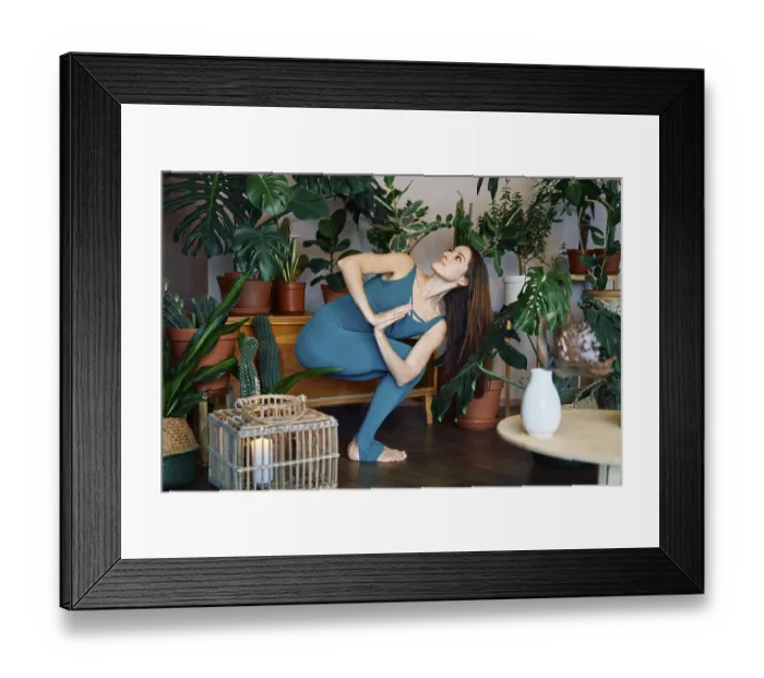 Framed Print : Young sporty woman practicing yoga at home doing prayer twist pose