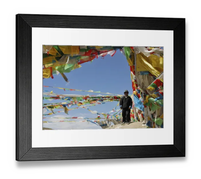 Framed Print : Tibetan man surrounded by prayer flags