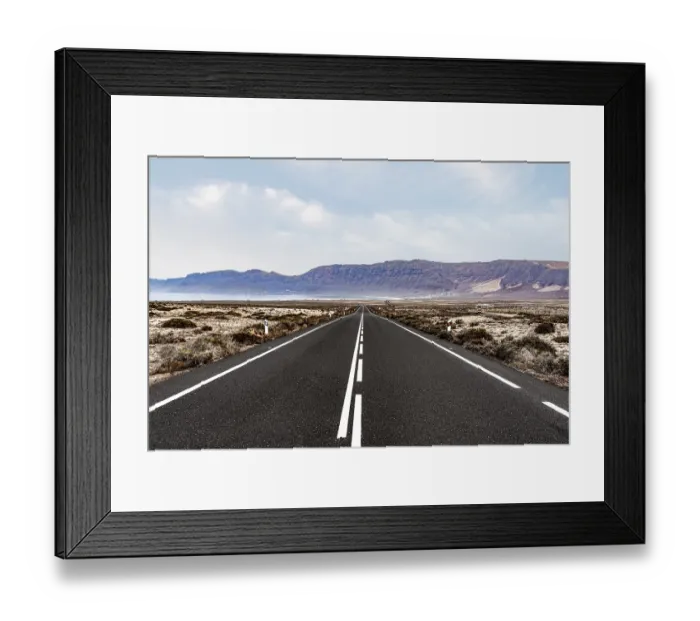 Framed Print : long straight empty asphalt road through arid landscape against ocean and mountain range on Lanzarote Framed Print : long straight empty asphalt road through arid landscape against ocean and mountain range on Lanzarote