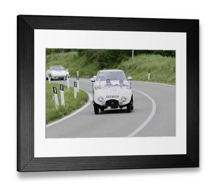Framed Print : Classic white racing car driving on a winding country road through green fields on a sunny day Framed Print : Classic white racing car driving on a winding country road through green fields on a sunny day