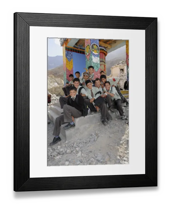 Framed Print : Students wearing uniforms in front of a prayer wheel in Hunder Framed Print : Students wearing uniforms in front of a prayer wheel in Hunder