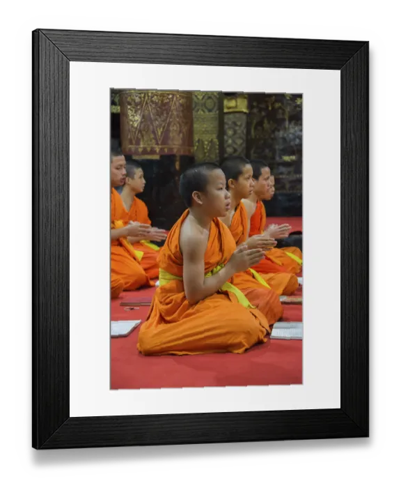 Framed Print : Buddhist monks praying in the temple Wat Xieng Thong