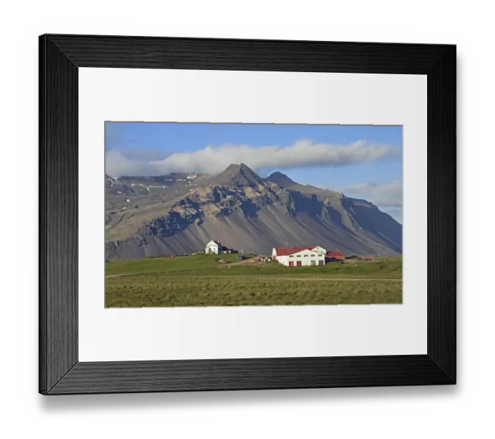Framed Print : Farm and mountain scenery with eroded scree slope in the evening light near Hofn