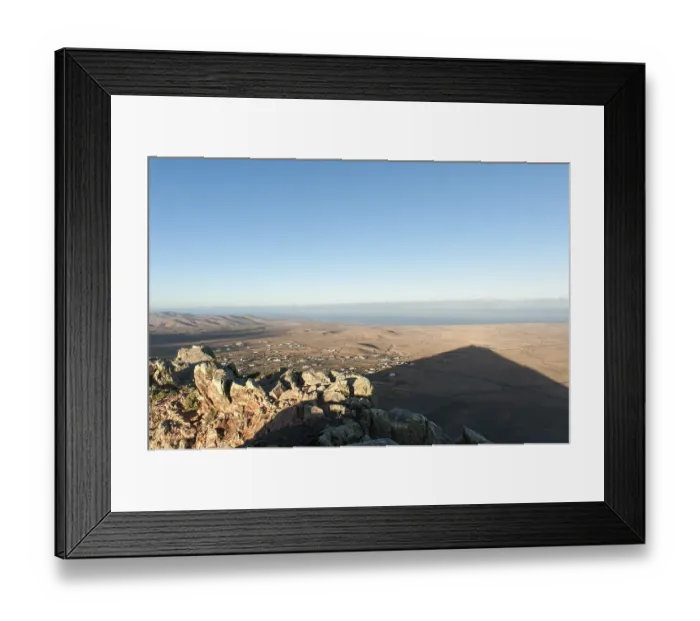 Framed Print : Mountain shadow in the shape of a triangle in the landscape