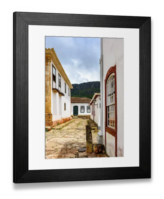 Framed Print : Paving stones made by slaves on the streets with colonial-style houses in the city of Tiradentes city