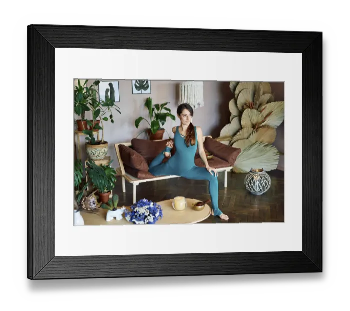 Framed Print : Young sporty woman practicing yoga at home