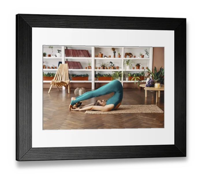 Framed Print : Young sporty woman practicing yoga at home doing exercise Halasana Plow Pose